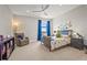 Bright bedroom with a blue bed, blue curtains, and dinosaur decorations at 16434 Slate Pl, Bradenton, FL 34211