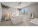 Inviting bedroom with a platform bed, soft lighting, and a large window offering natural light at 16434 Slate Pl, Bradenton, FL 34211