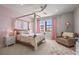 Stylish bedroom features a canopy bed with pink accents, a ceiling fan, and a cozy seating area at 16434 Slate Pl, Bradenton, FL 34211