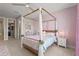 Charming bedroom featuring a canopy bed, soft pink accents, and lots of natural light at 16434 Slate Pl, Bradenton, FL 34211