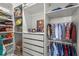 Bright walk-in closet with white shelves, drawers, and hanging rods for ample storage and organization at 16434 Slate Pl, Bradenton, FL 34211