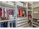 Organized walk-in closet featuring hanging rods, shelves, and drawers for optimal storage at 16434 Slate Pl, Bradenton, FL 34211