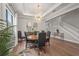 Elegant dining room with modern chandelier, hardwood floors, and large windows at 16434 Slate Pl, Bradenton, FL 34211