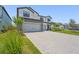 View of the home's exterior, highlighting the paver driveway and well-maintained landscaping, and a 2-car garage at 16434 Slate Pl, Bradenton, FL 34211