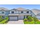 Beautiful two-story home with a stone-accented facade and well-manicured landscaping at 16434 Slate Pl, Bradenton, FL 34211