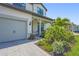 Close-up view of the home's entrance, showcasing the front porch, a two-car garage, and landscaped yard at 16434 Slate Pl, Bradenton, FL 34211