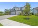 Charming two-story home with a stone facade and a well-manicured lawn. Paved driveway to the 2-car garage at 16434 Slate Pl, Bradenton, FL 34211