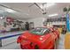 Well-lit garage featuring epoxy floors and ample space for car parking and storage at 16434 Slate Pl, Bradenton, FL 34211