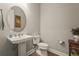 Elegant half bathroom with pedestal sink, stylish mirror, and neutral decor at 16434 Slate Pl, Bradenton, FL 34211
