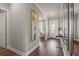 Inviting hallway with hardwood floors, neutral paint, and view to the foyer at 16434 Slate Pl, Bradenton, FL 34211