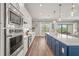 Bright, open kitchen featuring a large island with seating and stainless steel appliances at 16434 Slate Pl, Bradenton, FL 34211