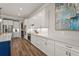 Bright kitchen featuring white cabinetry, a large center island, and stainless steel appliances. Hardwood floors at 16434 Slate Pl, Bradenton, FL 34211
