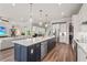 Open concept kitchen with large island, stainless appliances, and pendant lighting at 16434 Slate Pl, Bradenton, FL 34211