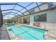 Gorgeous screened pool area with brick pavers and views of the home's white exterior at 16434 Slate Pl, Bradenton, FL 34211