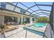 Screened-in pool area with hot tub, lounge chairs, outdoor dining, and seating at 16434 Slate Pl, Bradenton, FL 34211