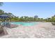 Relaxing community pool area with lounge chairs and umbrellas, perfect for sunny afternoons at 16434 Slate Pl, Bradenton, FL 34211