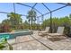 Inviting pool deck with lounge chairs and a hot tub, all screened in at 16434 Slate Pl, Bradenton, FL 34211