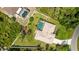 Aerial view of the property featuring a screened pool, fenced yard, and mature landscaping at 1667 Oakland Rd, North Port, FL 34286
