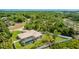 Aerial view showcasing the screened-in pool, mature trees, and fenced backyard, providing privacy at 1667 Oakland Rd, North Port, FL 34286
