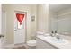Simple bathroom design with walk-in shower, single sink vanity, and door to the outside at 1667 Oakland Rd, North Port, FL 34286