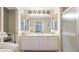 Bright bathroom featuring a vanity with double sinks and a walk-in shower at 1667 Oakland Rd, North Port, FL 34286