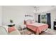 Cozy bedroom with decorative wall art, sitting area, and a window letting in natural light at 1667 Oakland Rd, North Port, FL 34286