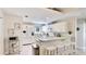 Bright kitchen with white cabinetry, bar-style seating, and modern appliances at 1667 Oakland Rd, North Port, FL 34286