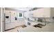 Well-lit kitchen with white appliances and cabinetry and modern faucet at 1667 Oakland Rd, North Port, FL 34286