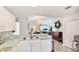 Open kitchen with countertop seating and a view into the dining and living areas at 1667 Oakland Rd, North Port, FL 34286