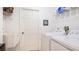 Laundry room featuring modern washer and dryer units, sink, and shelving at 1667 Oakland Rd, North Port, FL 34286