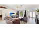 Bright living room featuring tile flooring, arched windows with curtains, and comfortable leather seating at 1667 Oakland Rd, North Port, FL 34286