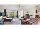Inviting living room with arched windows overlooking the yard, comfortable seating, and neutral decor at 1667 Oakland Rd, North Port, FL 34286