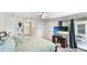 Comfortable main bedroom with a television, sliding doors to patio, and en-suite bathroom at 1667 Oakland Rd, North Port, FL 34286