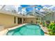 An enclosed in-ground pool with lush landscaping, and plenty of outdoor seating at 1667 Oakland Rd, North Port, FL 34286