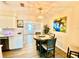Bright dining area with modern chandelier and views of the kitchen and living room at 1708 Tarpon Ave, Sarasota, FL 34234