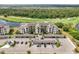 Aerial view of condo complex with mature landscaping, covered parking, pond and golf course views at 17510 Gawthrop Dr # 208, Bradenton, FL 34211