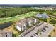Aerial view of condo complex showcasing its lush surroundings, golf course, and parking at 17510 Gawthrop Dr # 208, Bradenton, FL 34211