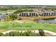Aerial view showcasing the golf course and condo complex nestled amidst lush greenery and ponds at 17510 Gawthrop Dr # 208, Bradenton, FL 34211
