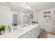 Bathroom with a double vanity, stylish fixtures, and a view into the bedroom at 17510 Gawthrop Dr # 208, Bradenton, FL 34211