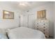 Bright bedroom features queen bed, stylish furnishings, and closet at 17510 Gawthrop Dr # 208, Bradenton, FL 34211