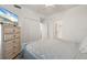 Bright bedroom features a dresser with a television, closet, and bathroom access at 17510 Gawthrop Dr # 208, Bradenton, FL 34211