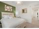 Bright bedroom features queen bed, stylish furnishings, and vibrant accent wall at 17510 Gawthrop Dr # 208, Bradenton, FL 34211