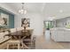 Bright dining room with a modern chandelier, stylish decor, and an open floor plan at 17510 Gawthrop Dr # 208, Bradenton, FL 34211