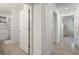 Hallway featuring access to bedrooms and bathrooms with tiled flooring and neutral decor at 17510 Gawthrop Dr # 208, Bradenton, FL 34211