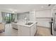 Bright kitchen featuring white cabinets, modern appliances, and an open view to the living area at 17510 Gawthrop Dr # 208, Bradenton, FL 34211