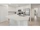 Modern kitchen with white cabinets, stainless steel appliances, and a spacious center island at 17510 Gawthrop Dr # 208, Bradenton, FL 34211