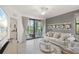 Comfortable living room with a neutral color palette, balcony access, and tile flooring at 17510 Gawthrop Dr # 208, Bradenton, FL 34211
