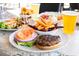 An array of appetizing foods that include an open-faced burger, a salad, some onion rings and a drink at 17510 Gawthrop Dr # 208, Bradenton, FL 34211