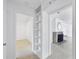 Hallway and interior view of open floorplan with fireplace, shelving, and Terrazzo flooring at 1773 South Dr, Sarasota, FL 34239
