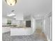 Bright kitchen featuring white cabinetry, stone countertops, stainless steel appliances, and a breakfast bar at 1773 South Dr, Sarasota, FL 34239